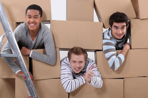 Professional movers carrying furniture in a Barnet home