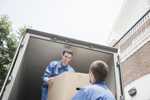 Worker assessing and lifting a boxed item carefully